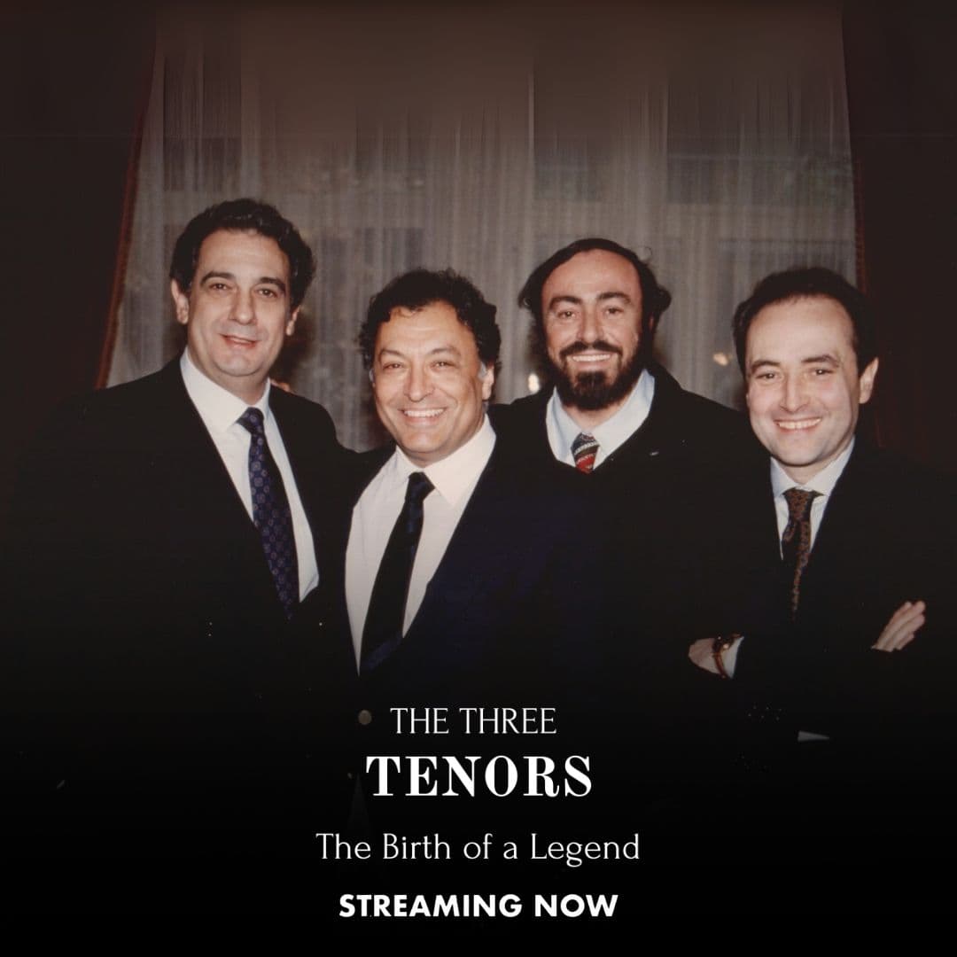 The Three Tenors stand together and smile in front of a curtain; text at the bottom reads, “The Three Tenors: The Birth of a Legend. Streaming Now.”.