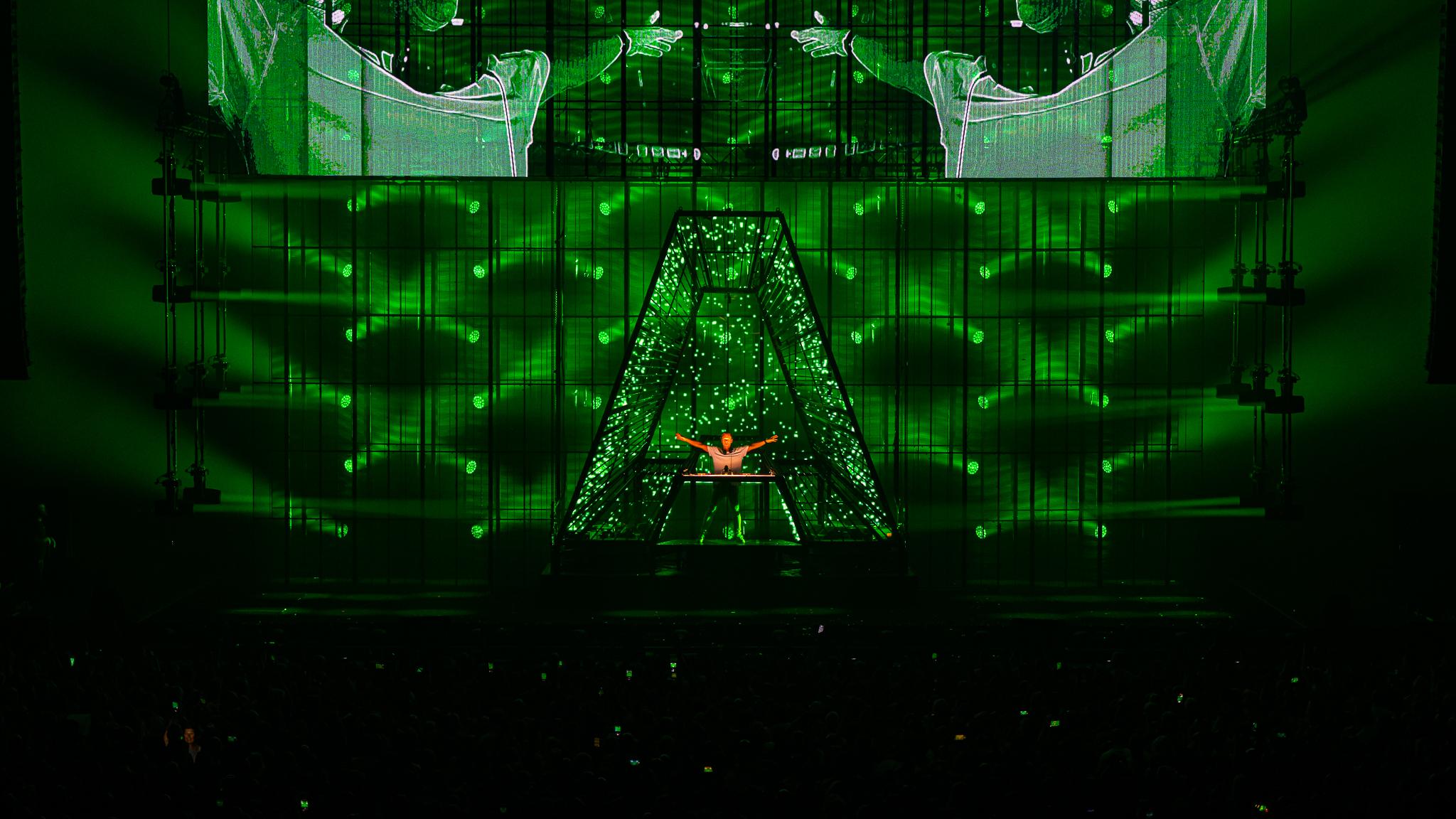 Armin van Buuren live on stage stood inside giant green letter A